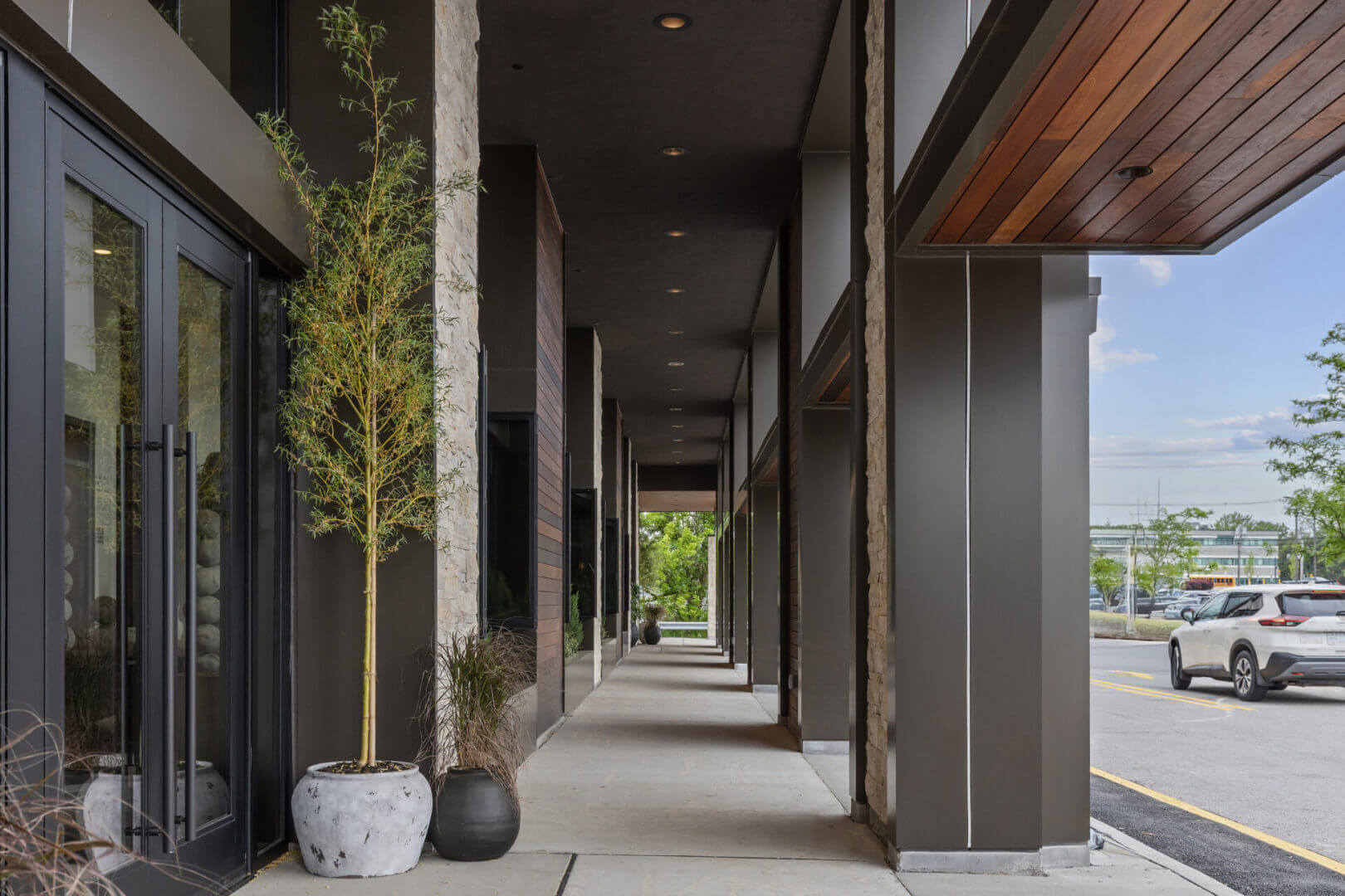 Modern building exterior with potted plants.