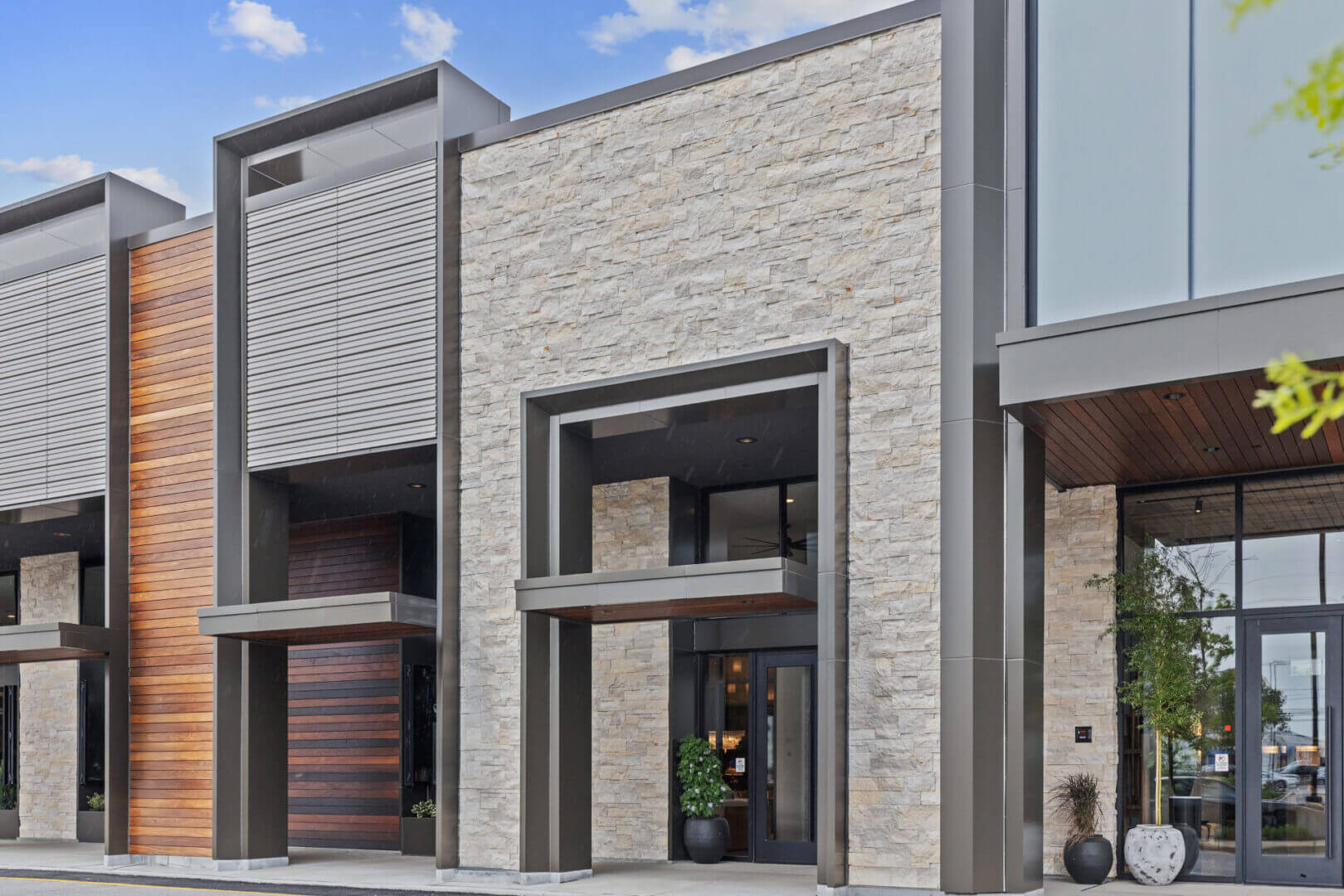 Modern building facade with stone and wood.