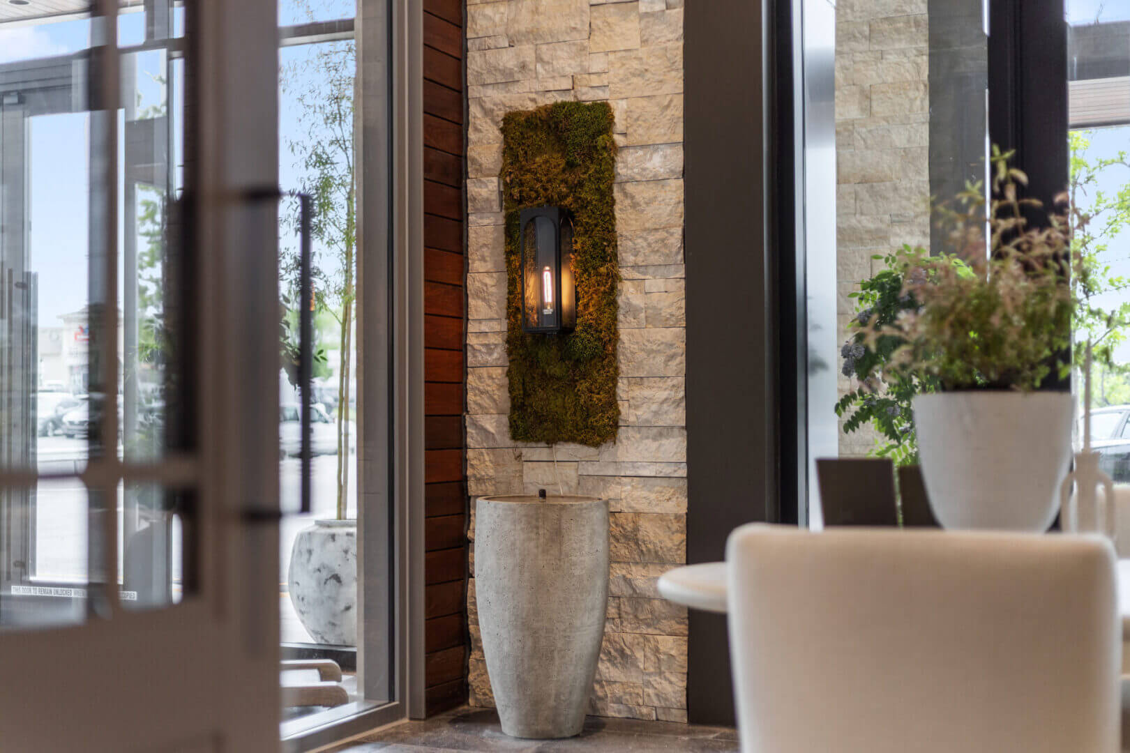 Elegant interior with plants and stone wall.